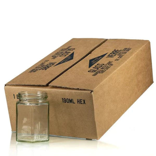 Hexagon Glass Jar with Gold Lid, 190 ml capacity, next to packaging box.