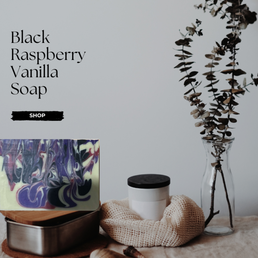 Artisan soap with black raspberry vanilla swirl on a neutral background with decor items.