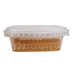 Raw honeycomb in a clear container, showcasing pure, unfiltered honey.