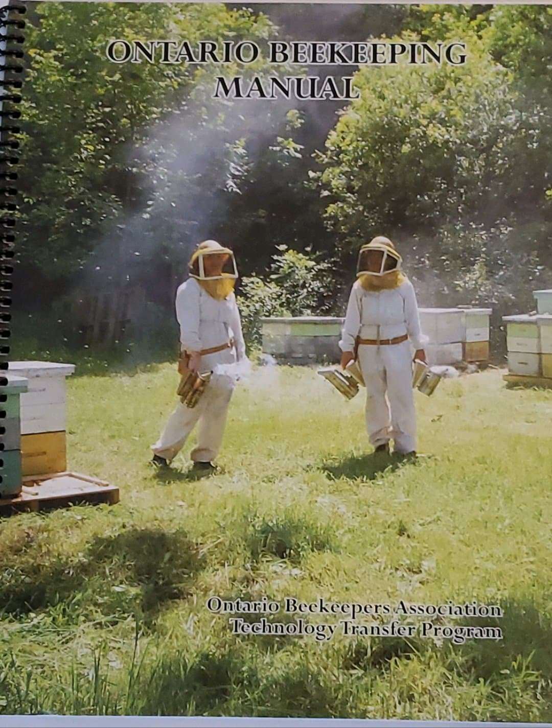 Ontario Beekeeping Manual cover featuring beekeepers in protective suits near hives.