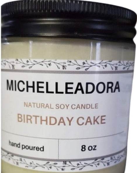 Birthday Cake Soy Candle in a glass jar with black metal lid, 8 oz, vanilla scent.